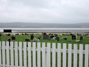 My first sight of the memorial was over the graveyard of the Lutheran church. The section to the right was designed by the architect Peter Zumthor, while Louise Bourgeois designed the structure to the left and its contents. — at Steilneset Memorial in Vardø, Norway .