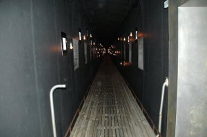 This is the first thing you see when you step inside the structure: a long corridor lined with plaques, lights and small windows. — at Steilneset Memorial in Vardø, Norway.
